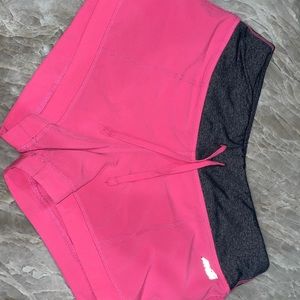 One black and one pink pair of workout shorts